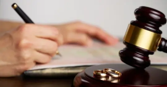 close-up of a person signing divorce document